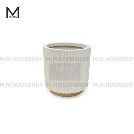 White textured ceramic planter on a white background with M.M. Noorbhooy branding.